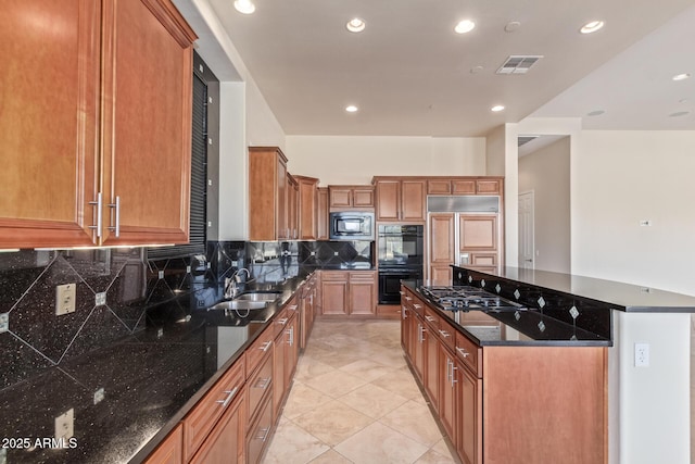 kitchen with sink, dark stone countertops, backsplash, built in appliances, and light tile patterned flooring