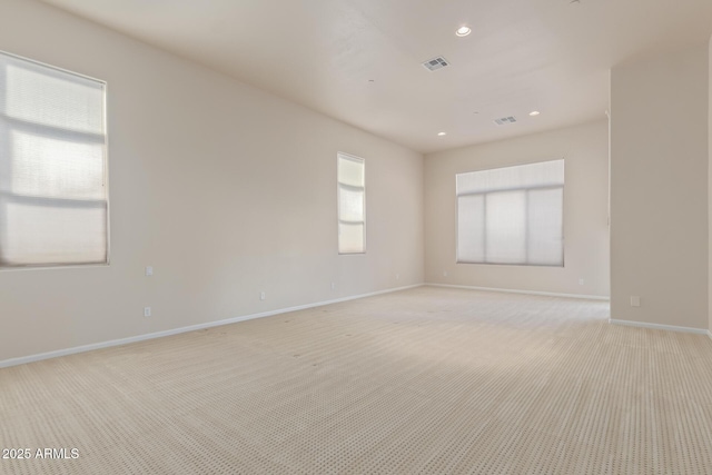 spare room featuring light colored carpet