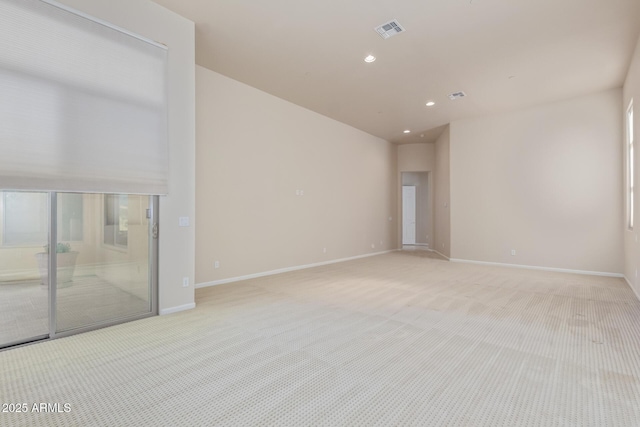 unfurnished room featuring plenty of natural light and light carpet