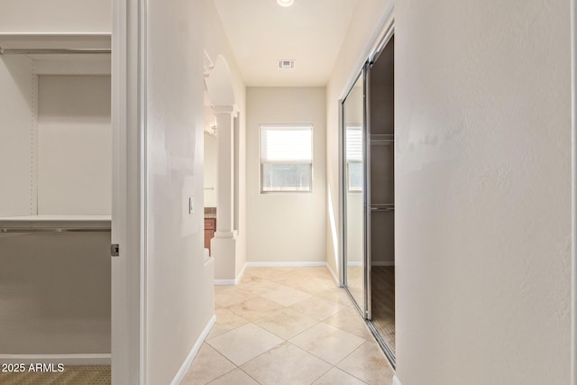 hallway with light tile patterned floors