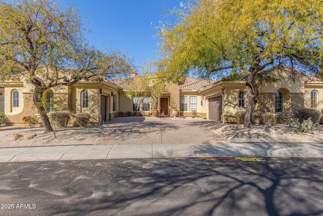 mediterranean / spanish-style home featuring a garage