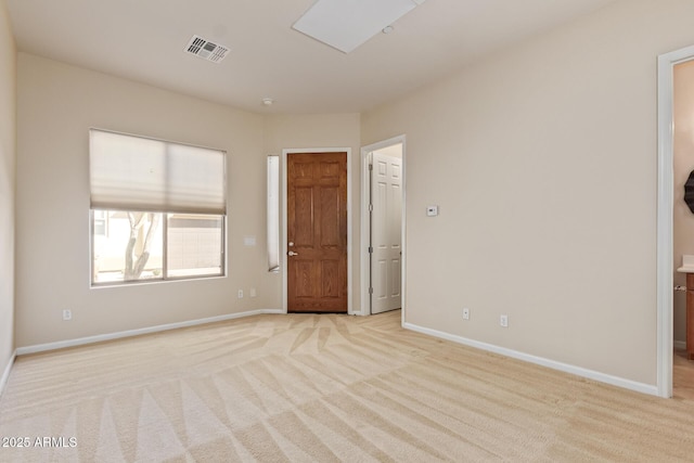 spare room featuring light carpet