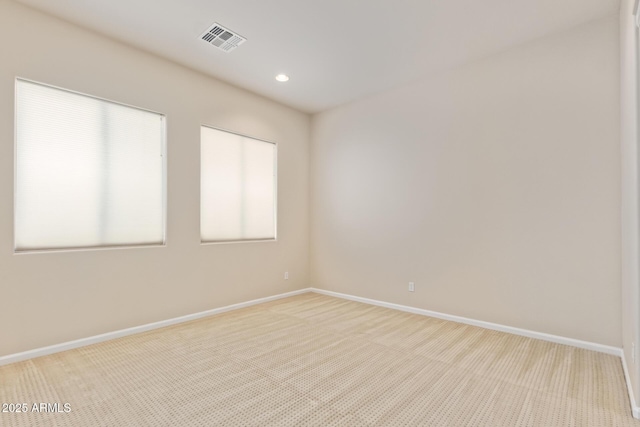 unfurnished room featuring light carpet