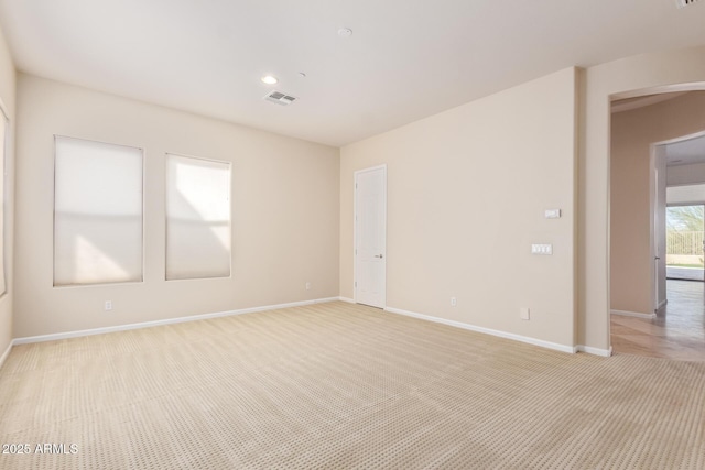 empty room featuring light colored carpet