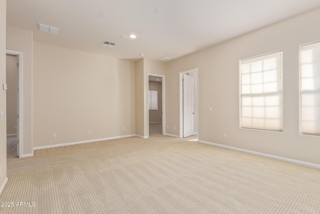 unfurnished room featuring light colored carpet