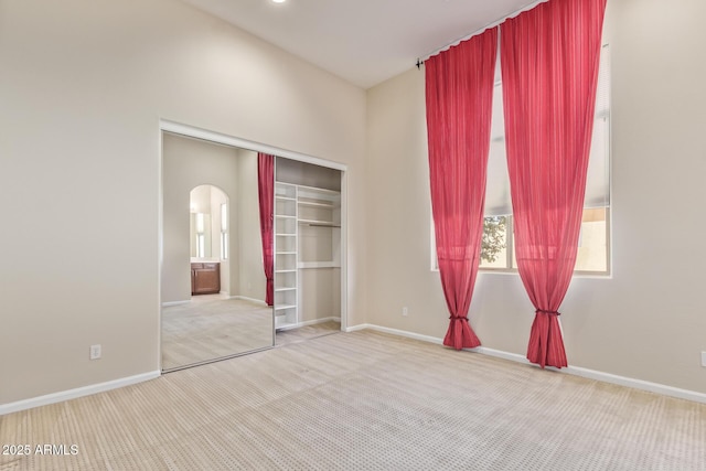 unfurnished bedroom featuring carpet and a closet