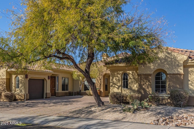 mediterranean / spanish-style home featuring a garage