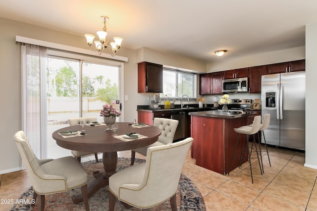 2922 S Cottonwood Dr, Tempe, AZ 85282 - kitchen featuring stainless steel appliances, dark countertops, a chandelier, a sink, and a kitchen island