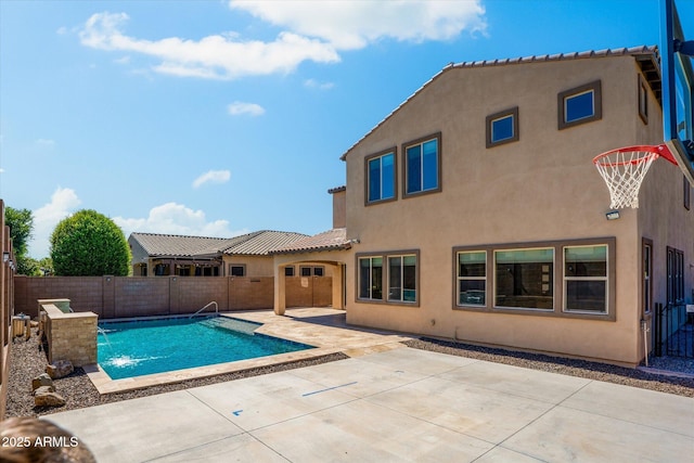 view of pool featuring pool water feature and a patio area