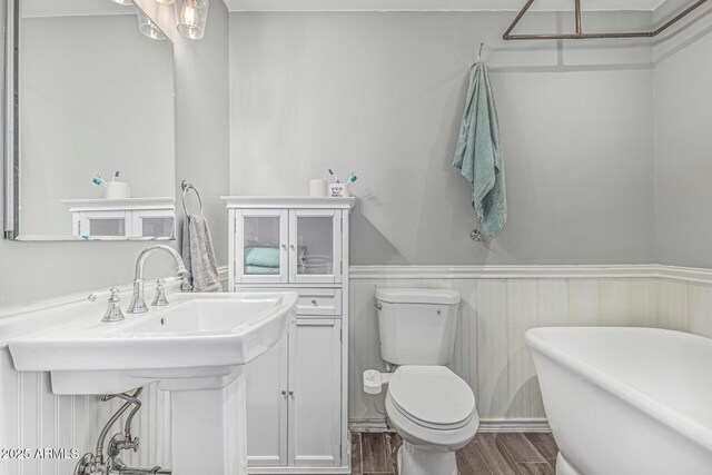 591 N Cheri Lynn Dr, Chandler, AZ 85225 - full bathroom with a freestanding tub, wood finished floors, toilet, and wainscoting