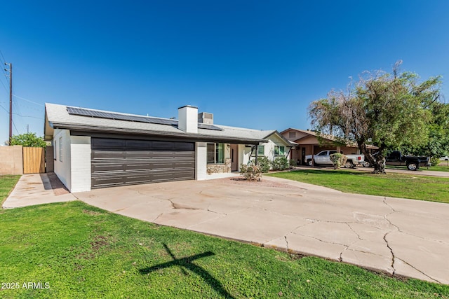 591 N Cheri Lynn Dr, Chandler, AZ 85225 - view of front facade with driveway, a garage, roof mounted solar panels, and a chimney