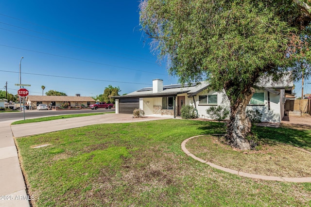 591 N Cheri Lynn Dr, Chandler, AZ 85225 - ranch-style home featuring driveway, solar panels, a front lawn, a garage, and a chimney