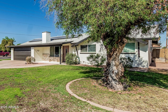 591 N Cheri Lynn Dr, Chandler, AZ 85225 - ranch-style home featuring an attached garage, concrete driveway, a front yard, roof mounted solar panels, and a chimney