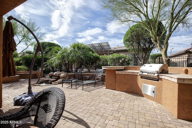 26293 W Runion Ln, Buckeye, AZ 85396 - view of patio featuring grilling area, an outdoor kitchen, and fence