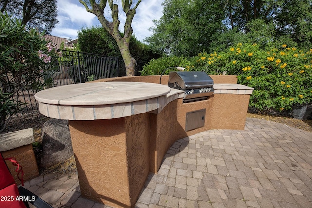 26293 W Runion Ln, Buckeye, AZ 85396 - view of patio with exterior kitchen, fence, and a grill