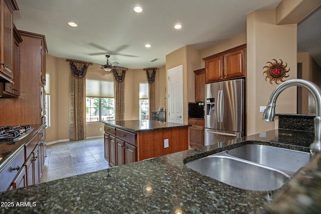 26293 W Runion Ln, Buckeye, AZ 85396 - kitchen with ceiling fan, a sink, baseboards, stainless steel fridge, and recessed lighting