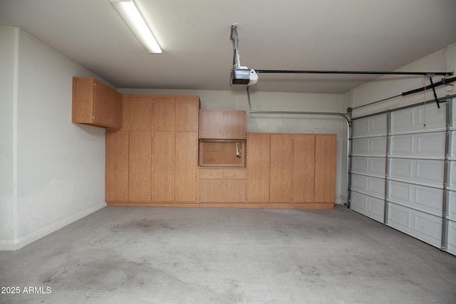 26293 W Runion Ln, Buckeye, AZ 85396 - garage featuring baseboards and a garage door opener