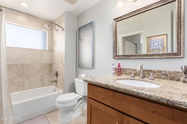 full bathroom featuring vanity, toilet, tiled shower / bath combo, and tile patterned flooring