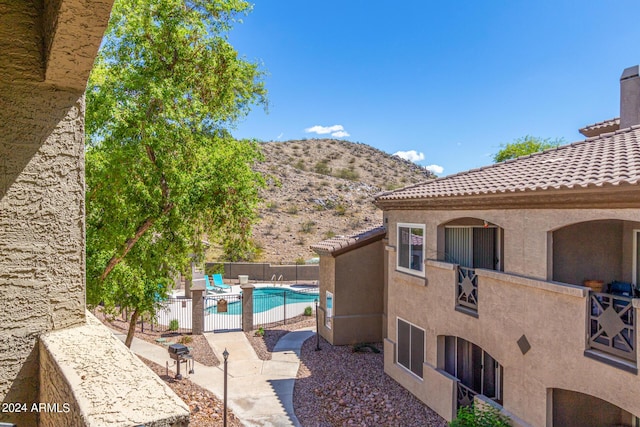 view of swimming pool with a mountain view and a patio area