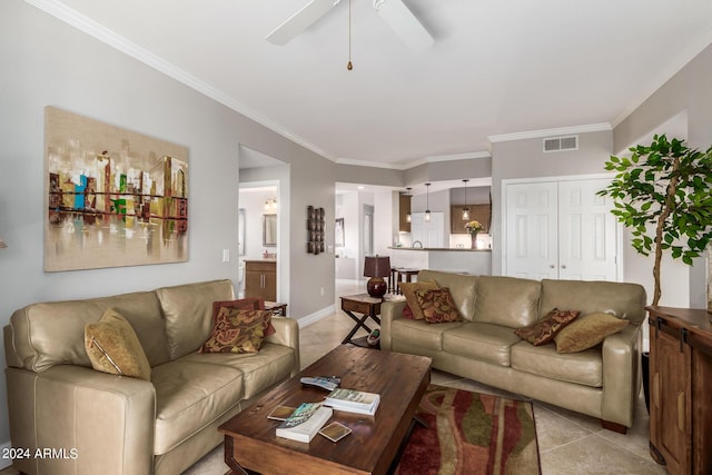 tiled living room with crown molding and ceiling fan