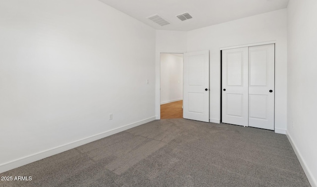 unfurnished bedroom with carpet floors and a closet