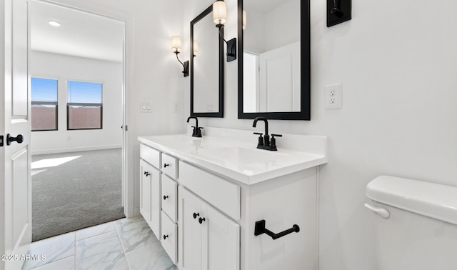 bathroom featuring vanity and toilet