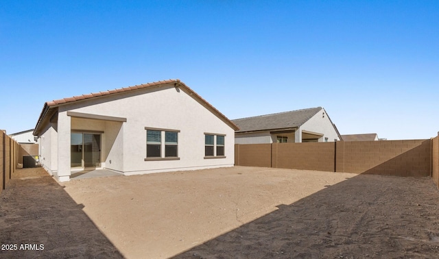 rear view of house featuring a patio area and cooling unit