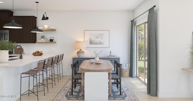 dining space with sink and light hardwood / wood-style flooring