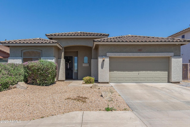 mediterranean / spanish-style house with stucco siding, a garage, and concrete driveway