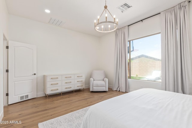 bedroom with a chandelier, light wood finished floors, recessed lighting, and baseboards