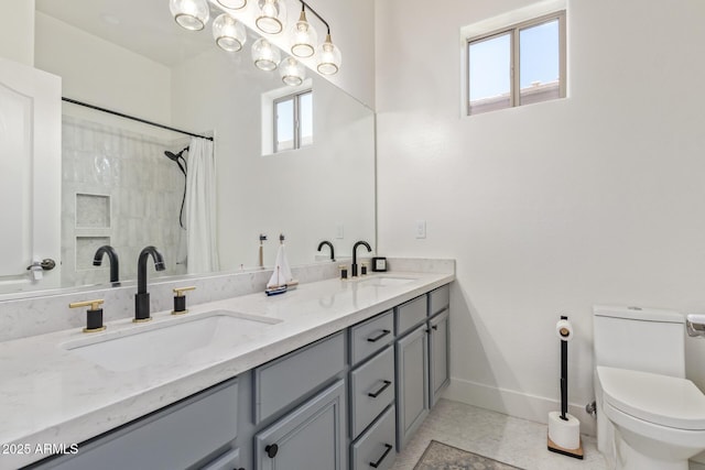 full bathroom with baseboards, toilet, double vanity, and a shower with curtain
