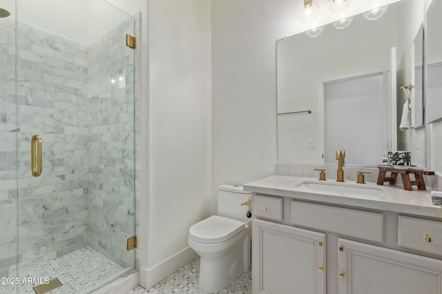 full bathroom with toilet, vanity, a stall shower, and baseboards