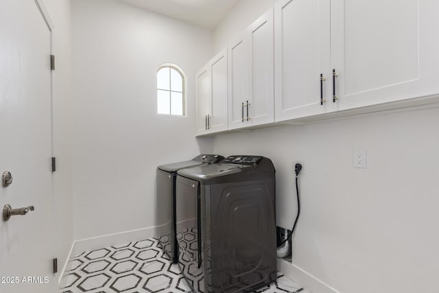 laundry area with separate washer and dryer, cabinet space, and baseboards