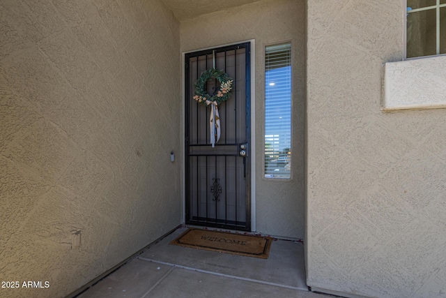entrance to property with stucco siding