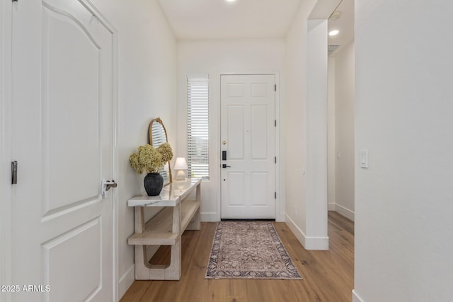 entrance foyer with light wood-type flooring, baseboards, and recessed lighting