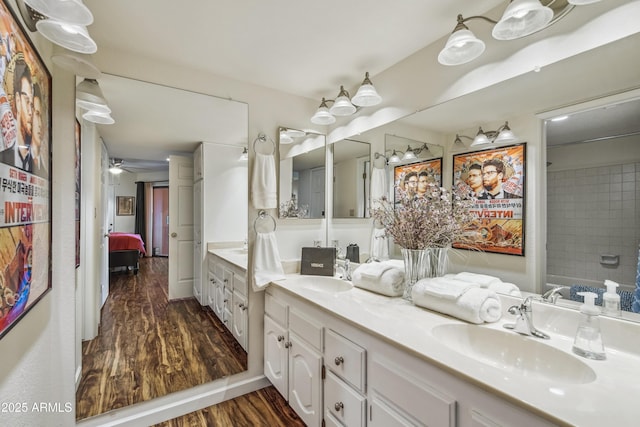12222 N Paradise Village Pkwy S Unit 442, Phoenix, AZ 85032 - bathroom featuring wood finished floors, double vanity, ensuite bath, and a ceiling fan