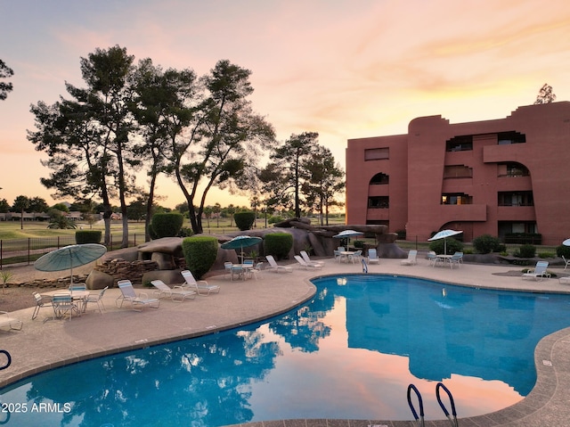 12222 N Paradise Village Pkwy S Unit 442, Phoenix, AZ 85032 - pool at dusk featuring a patio and a community pool