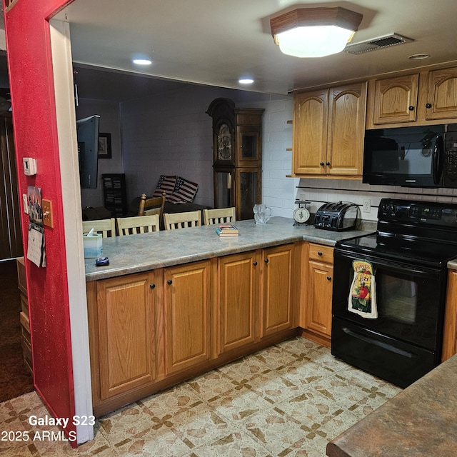 kitchen with tasteful backsplash and black appliances