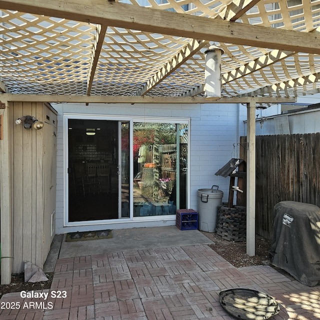 entrance to property with a pergola and a patio area