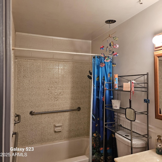 bathroom with shower / bathtub combination with curtain and toilet