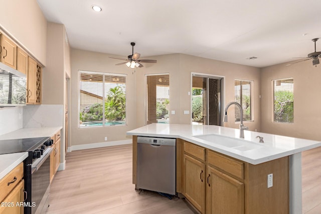 22322 N 77th St, Scottsdale, AZ 85255 - kitchen with appliances with stainless steel finishes, a sink, a ceiling fan, light wood finished floors, and light countertops