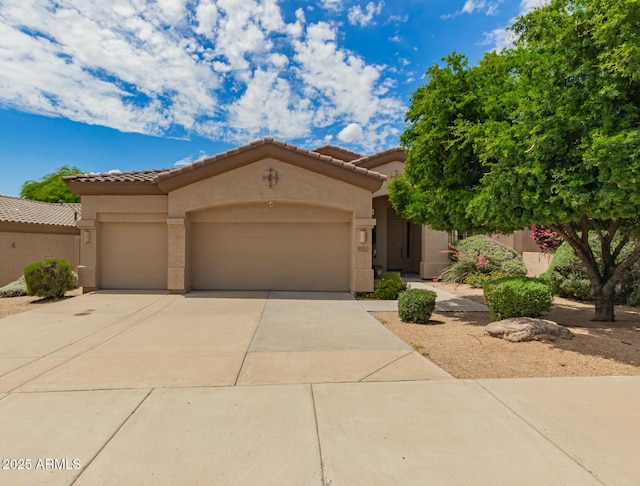 22322 N 77th St, Scottsdale, AZ 85255 - view of front of house featuring an attached garage, stucco siding, driveway, and a tiled roof