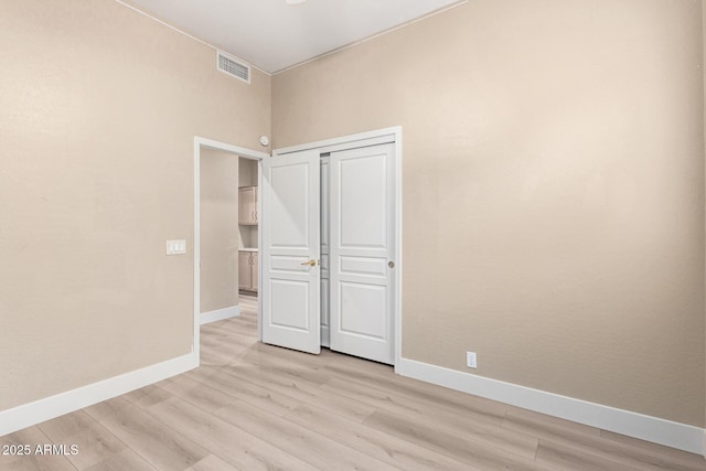 22322 N 77th St, Scottsdale, AZ 85255 - unfurnished bedroom with baseboards, light wood-type flooring, and a closet