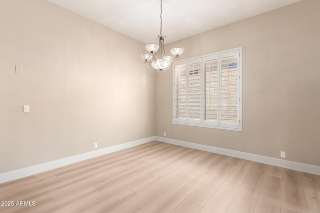 22322 N 77th St, Scottsdale, AZ 85255 - spare room with a chandelier, light wood finished floors, and baseboards