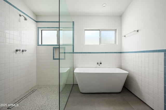 7646 E Catalina Dr, Scottsdale, AZ 85251 - bathroom featuring tile walls, a tile shower, a wealth of natural light, and a freestanding bath