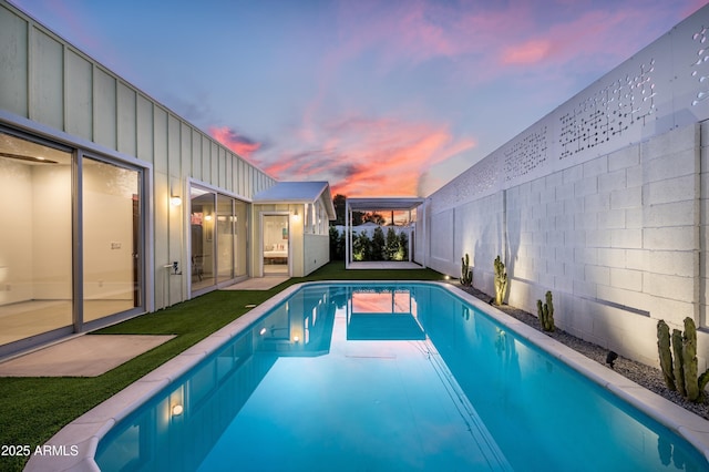 7646 E Catalina Dr, Scottsdale, AZ 85251 - pool at dusk with a fenced backyard and an outdoor pool