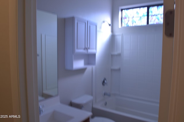 bathroom with shower / bathtub combination, vanity, and toilet