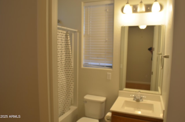 bathroom featuring toilet, curtained shower, and vanity