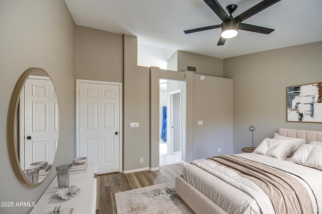 bedroom with a ceiling fan, wood finished floors, and visible vents