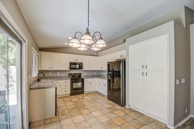 kitchen featuring light stone countertops, a sink, black appliances, vaulted ceiling, and white cabinetry